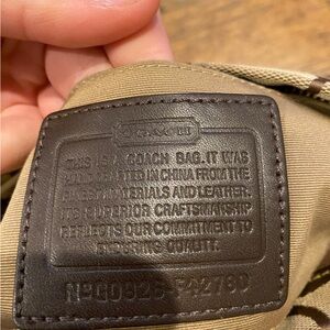 Brown held hand coach bag